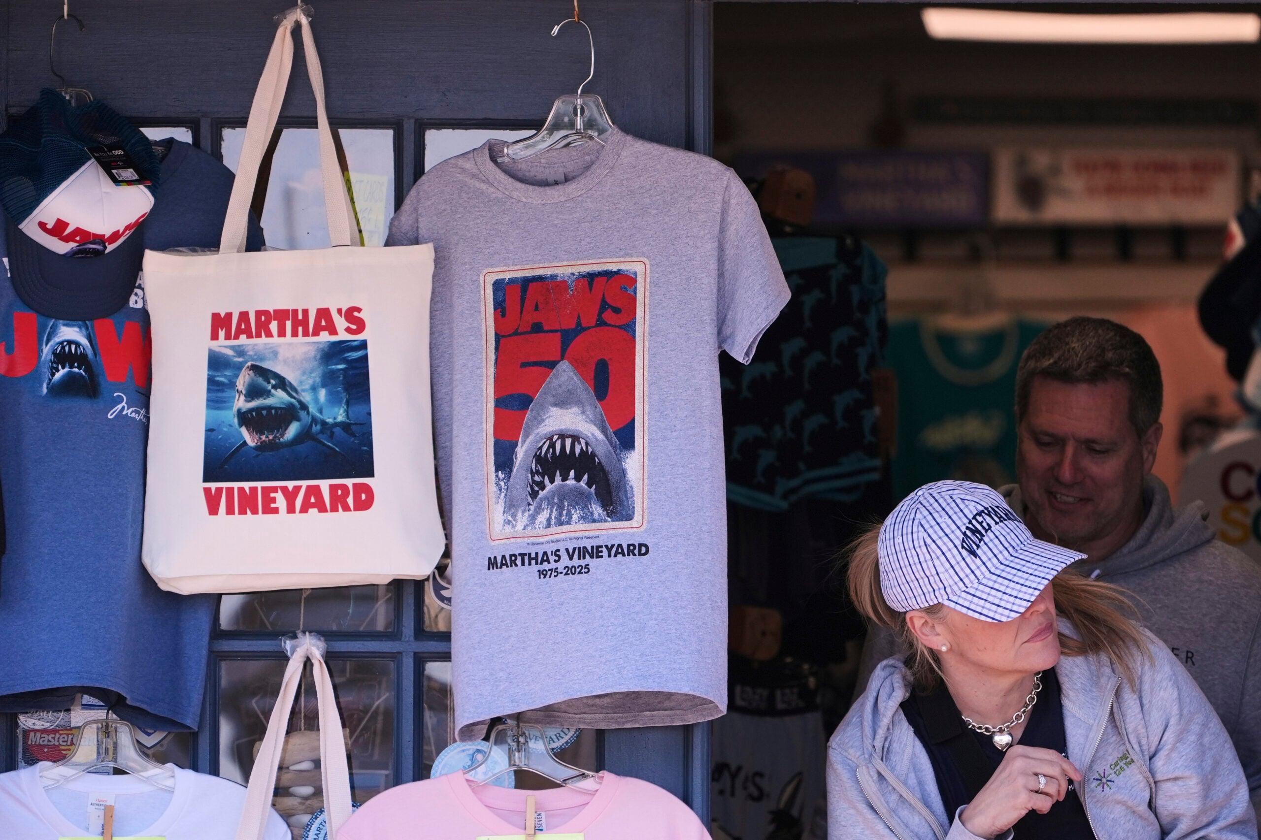 A shopper walks past items featuring the Jaws movie at Neptune's Sea Chest gift shop.