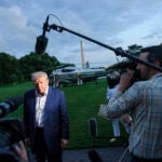 President Donald Trump speaks with reporters.