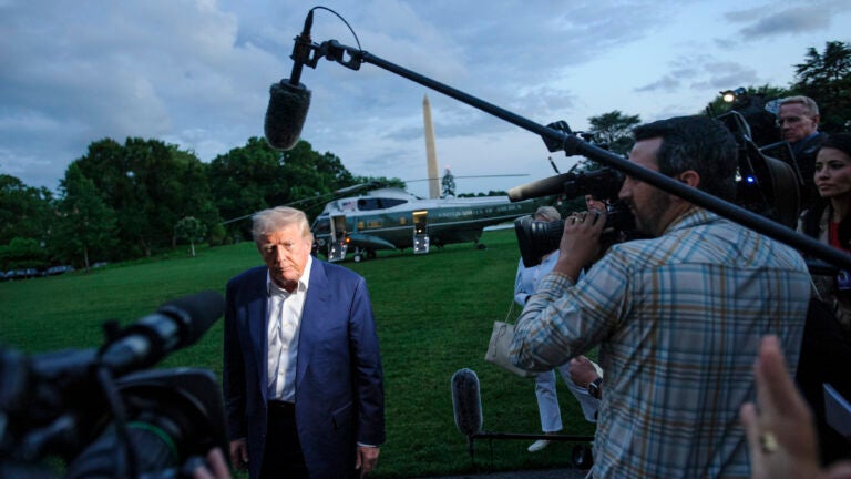 President Donald Trump speaks with reporters.