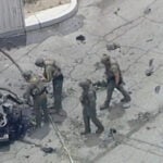 Law enforcement investigate a vehicle after an explosion on Saturday, May 17, 2025 in Palm Springs, Calif.