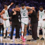 Trainers help Boston Celtics' Jayson Tatum (0) off the court after he was injured during the second half of Game 4 in the Eastern Conference semifinals of the NBA basketball playoffs against the New York Knicks Monday, May 12, 2025, in New York.