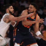 New York Knicks' Karl-Anthony Towns, right, looks to pass the ball past Boston Celtics' Jayson Tatum, left, during the second half of an NBA basketball game, Tuesday, April 8, 2025, in New York.