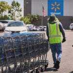 Empty shopping carts are collected from the parking lot at Walmart.