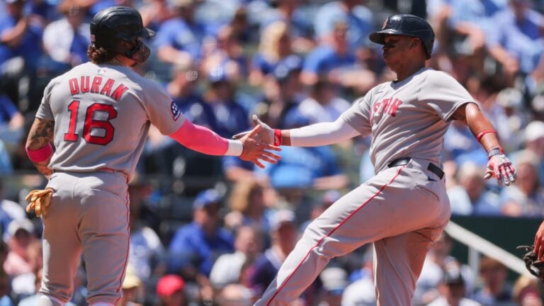 Rafael Devers celebrates with Jarren Duran after hitting a two run home run during the sixth inning at Kauffman Stadium on May 11, 2025 in Kansas City, Missouri.