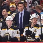 CHICAGO, ILLINOIS - DECEMBER 04: Assistant coach Jay Leach of the Boston Bruins looks on against the Chicago Blackhawks during the first period at the United Center on December 04, 2024 in Chicago, Illinois.