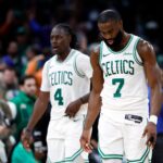 Boston, MA - 5/5/25- Boston Celtics guards Jaylen Brown (7) and Jrue Holiday (4) walk off the court after falling to the New York Knicks in overtime in game one of the NBA Eastern Conference semifinal at TD Garden.
