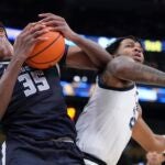 Marquette's Chase Ross and Georgetown's Thomas Sorber battle for a loose ball during the first half of an NCAA college basketball game Tuesday, Jan. 7, 2025, in Milwaukee.