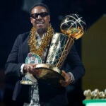 Former Boston Celtic Paul Pierce carries the Larry O’Brien Championship trophy during the NBA championship banner raising at TD Garden.