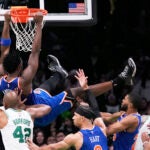 Knicks forward OG Anunoby hangs from the rim after dunking against the Celtics during the second half of Game 1 of their second-round playoff series Monday, May 5, 2025, in Boston.