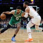 Boston Celtics' Jayson Tatum (0) looks to move past New York Knicks' Jalen Brunson (11) during the second half of an NBA basketball game Sunday, Feb. 23, 2025, in Boston.