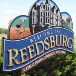 A welcome sign stands at the entrance of the city of Reedsburg, Wis., in July 2020.