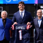 New England Patriots first round draft pick Will Campbell, center, an offensive tackle from LSU, poses with team owner Robert Kraft, left, and team president Jonathan Kraft during an NFL football media availability on the field, Friday, April 25, 2025, in Foxborough, Mass.