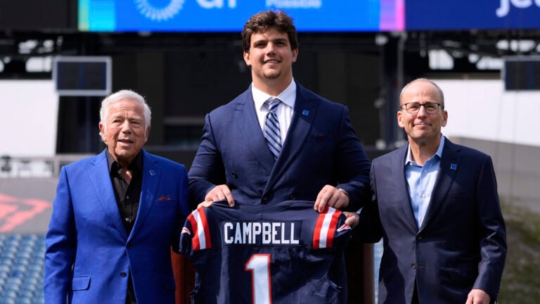 New England Patriots first round draft pick Will Campbell, center, an offensive tackle from LSU, poses with team owner Robert Kraft, left, and team president Jonathan Kraft during an NFL football media availability on the field, Friday, April 25, 2025, in Foxborough, Mass.