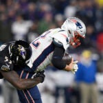 Baltimore Ravens defensive end Jihad Ward (53) sacks New England Patriots quarterback Tom Brady (12) on a third down play in the second half of an NFL football game, Sunday, Nov. 3, 2019, in Baltimore. The Ravens won 37-20.