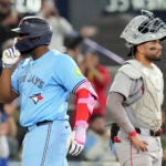 Toronto Blue Jays' Vladimir Guerrero Jr. gestures as he crosses the plate in front of Red Sox catcher Carlos Narvaez after hitting a three-run home run during eighth-inning.