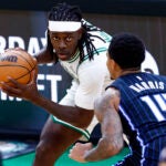 Boston Celtics guard Jrue Holiday (4) goes up against Orlando Magic guard Gary Harris (14) during the fourth quarter in game one of the NBA Eastern Conference playoffs against the Orlando Magic at TD Garden. (Danielle Parhizkaran/Globe Staff)