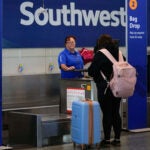 A Southwest Airlines traveler checks a bag.