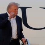 President Donald Trump gestures from the stairs of Air Force One upon his arrival at Joint Base Andrews, Md., Sunday, May 4, 2025.