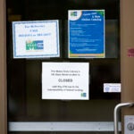 A sign announces the extended closure of the Maine State Library.