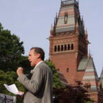 Ryan Enos, a government professor at Harvard University, speaks at a protest against President Donald Trump's recent sanctions against Harvard in front of Science Center Plaza.