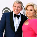 FILE - Julie Chrisley, right, and her husband Todd Chrisley pose for photos at the 52nd annual Academy of Country Music Awards April 2, 2017, in Las Vegas.