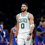 Boston Celtics forward Jayson Tatum (0) walks off the court after falling to the New York Knicks in overtime in game one of the NBA Eastern Conference semifinal at TD Garden.