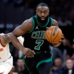 Boston Celtics guard Jaylen Brown (7) dribbles with New York Knicks guard Miles McBride (2) close behind during the second quarter in game five of the NBA Eastern Conference semifinal at TD Garden.