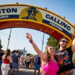 Katie McGinness and Brian Madigan take a photo in front of the Boston Calling welcome arch at Boston Calling on Saturday.
