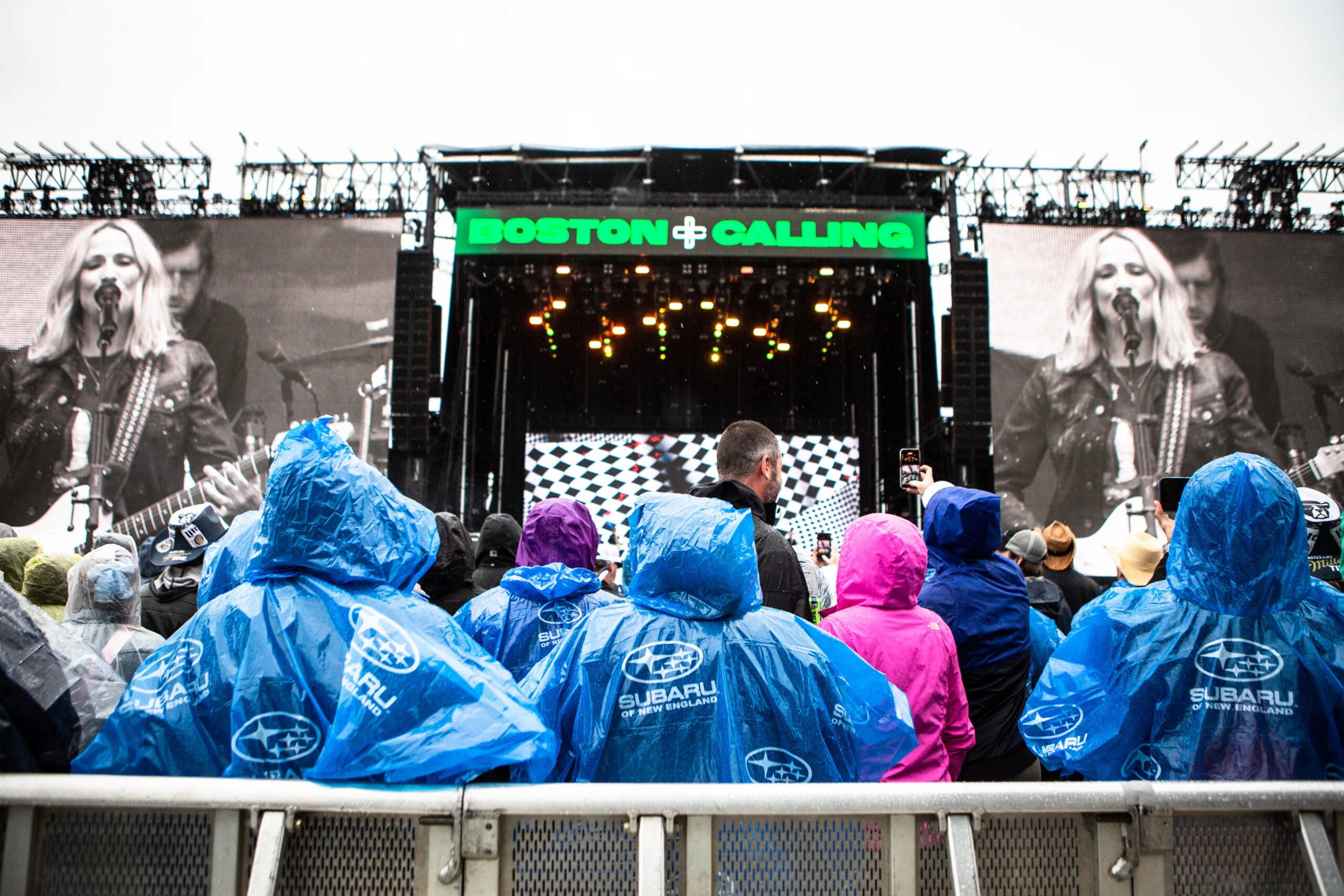 Poncho-clad fans take in a performance by Sheryl Crow at Boston Calling.