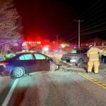 Members of the Litchfield Fire Department work on the scene after a fatal crash on Route 102.