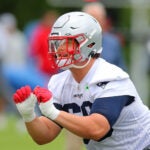 The NE Patriots held offseason workouts at the Gillette Stadium practice field. Will Campbell puts his arnms upo during a drill.