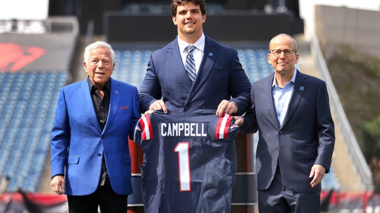 Patriots Robert Kraft presents a game jersey to Will Campbell along with Jonathan Kraft(rt) on the field of Gillette Stadium. The New England Patriots welcomed their first round draft choice, Will Campbell to Gillette Stadium where he was presented a game jersey and talked with the media on the field.