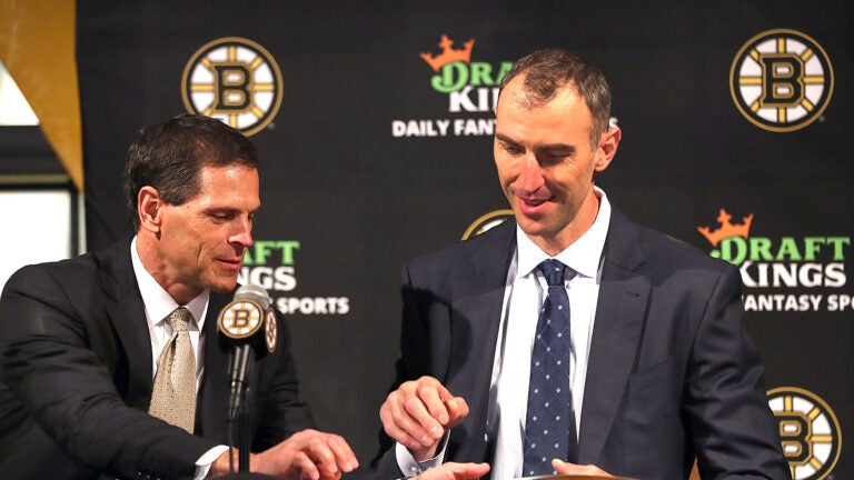 Zdeno Chara held a press conference at TD Garden to announce his retirement after he signed a one-day contract with the team to retire form the Bruins and the NHL. Don Sweeney(left) hands him the contract to sign.