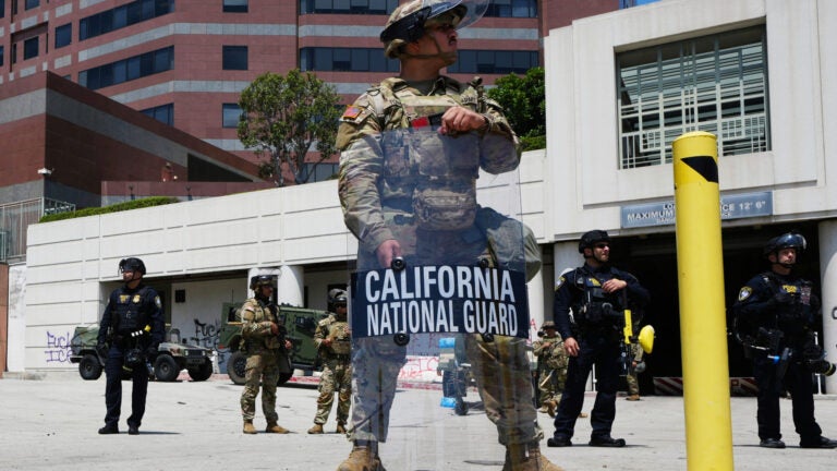 U.S. National Guard stand as they protect buildings Tuesday, June 10, 2025, in Los Angeles.