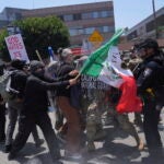 Protesters clash with authorities in downtown Los Angeles, Sunday, June 8, 2025,