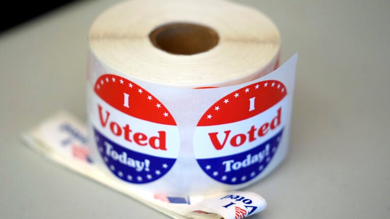 FILE - A spool of stickers rests on a table at a polling station during Massachusetts state primary voting, Sept. 3, 2024, in Newton, Mass.