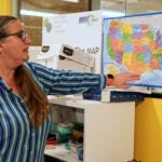 Dr. Angel Foster points to a map.