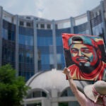 Katheryn Millwee holds a portrait of Kilmar Abrego Garcia outside the federal courthouse Wednesday, June 25, 2025, in Nashville, Tenn.