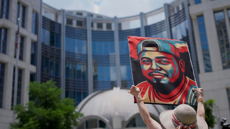 Katheryn Millwee holds a portrait of Kilmar Abrego Garcia outside the federal courthouse Wednesday, June 25, 2025, in Nashville, Tenn.