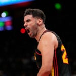 Atlanta Hawks forward Georges Niang (20) reacts after scoring n the first half of an NBA play-in tournament basketball game against the Miami Heat, Friday, April 18, 2025, in Atlanta.