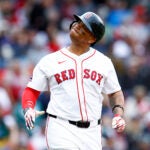 Rafael Devers (11) reacts after hitting a pop fly against the Baltimore Orioles during the seventh inning at Fenway Park.