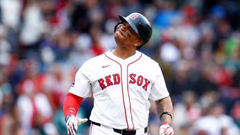 Rafael Devers (11) reacts after hitting a pop fly against the Baltimore Orioles during the seventh inning at Fenway Park.