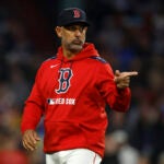 Red Sox manager Alex Cora signals to the infielders during the fourth inning at Fenway Park on June 9, 2025.