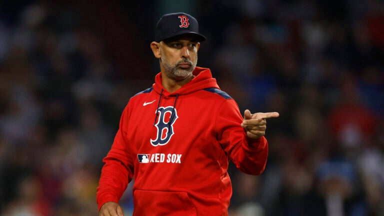 Red Sox manager Alex Cora signals to the infielders during the fourth inning at Fenway Park on June 9, 2025.