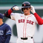 Boston Red Sox rookie Roman Anthony celebrates after his two RBI double, his first major league hit, during the first inning of a baseball game against the Tampa Bay Rays at Fenway Park, Tuesday, June 10, 2025, in Boston.