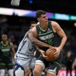 Minnesota Timberwolves center Luka Garza (55 gains control of a rebound against Orlando Magic center Wendell Carter Jr. (34) during the second half of an NBA basketball game, Thursday, Jan. 9, 2025, in Orlando, Fla.