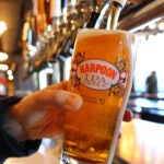 A bartender pours a beer at Harpoon Brewery.