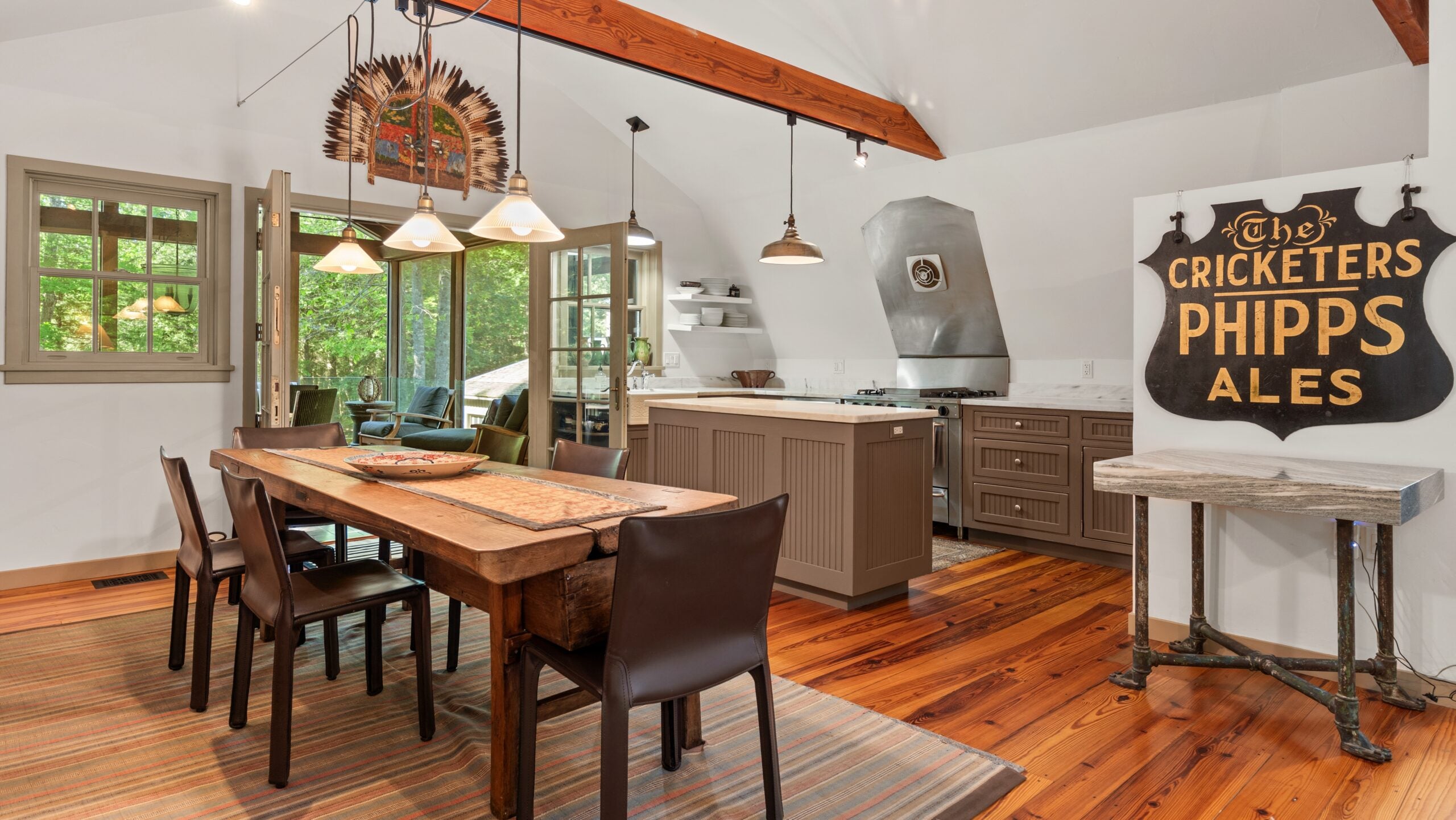 The kitchen features marble countertops, a farmhouse sink, and custom cabinetry.