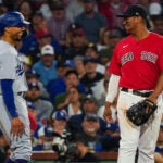 Los Angeles Dodgers second baseman Mookie Betts (50) and Boston Red Sox third baseman Rafael Devers (11) share a laugh with Betts on third during the seventh inning. The Boston Red Sox host the Los Angeles Dodgers on August 25, 2023 at Fenway Park in Boston, MA.