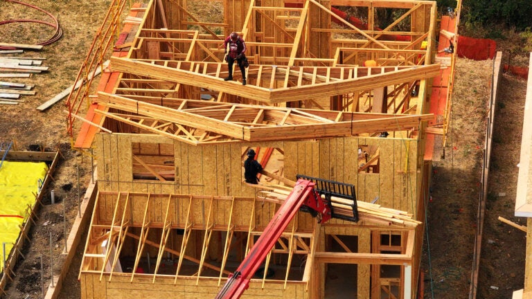 In an aerial view, construction workers build a home at a new housing development on July 1, 2025 in Hercules, Calif.